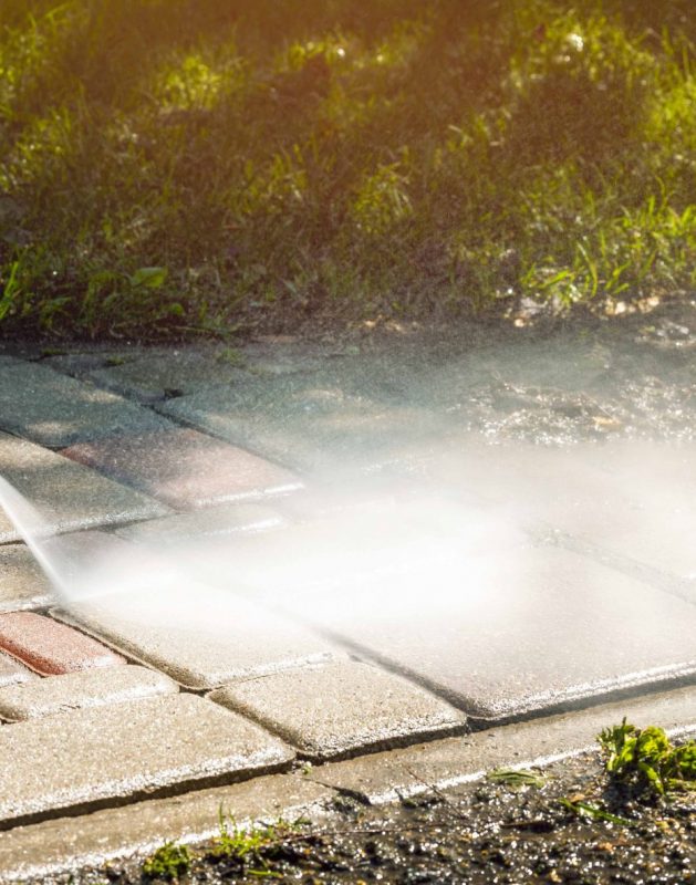 dirty block pavement cleaning with high pressure washer. copy sp